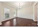 Formal dining room with hardwood floors, wainscoting, and natural lighting at 9937 Travertine Trl, Davidson, NC 28036