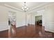 Spacious dining room with hardwood floors, decorative trim, and an open layout at 9937 Travertine Trl, Davidson, NC 28036