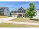 Beautiful two-story home boasts a brick facade, two-car garage, and landscaped front yard at 9937 Travertine Trl, Davidson, NC 28036