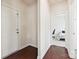 Entryway featuring hardwood floors leading to a bedroom with a desk and bed at 9937 Travertine Trl, Davidson, NC 28036
