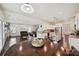 Open-concept kitchen boasts white cabinets, granite countertops, stainless steel appliances, and dark hardwood floors at 9937 Travertine Trl, Davidson, NC 28036