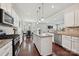 Kitchen featuring white cabinets, granite countertops, stainless steel appliances, and an island with barstool seating at 9937 Travertine Trl, Davidson, NC 28036