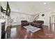 Hardwood floors, a fireplace, and comfortable seating create a warm and inviting ambiance in this living room at 9937 Travertine Trl, Davidson, NC 28036