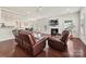 Open-concept living room with hardwood floors, fireplace, and large windows, providing a seamless flow for entertaining guests at 9937 Travertine Trl, Davidson, NC 28036