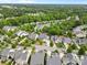 Aerial view of a neighborhood with mature trees, well-manicured lawns, and sidewalks at 11523 Warfield Ave, Huntersville, NC 28078
