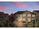 Back of home at dusk featuring a patio with a BBQ grill, and steps leading up to the backyard at 11523 Warfield Ave, Huntersville, NC 28078