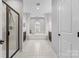 Bright bathroom with a glass enclosed shower, soaking tub with decorative columns, and neutral tile flooring at 11523 Warfield Ave, Huntersville, NC 28078