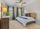 Bedroom with neutral walls, ceiling fan, and windows letting in natural light at 11523 Warfield Ave, Huntersville, NC 28078