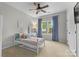 Bright bedroom featuring a twin bed and desk setup near a window letting in natural light at 11523 Warfield Ave, Huntersville, NC 28078