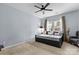 A cozy bedroom featuring a daybed with decorative pillows, a ceiling fan, and a comfortable armchair at 11523 Warfield Ave, Huntersville, NC 28078
