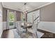 Elegant dining room with a modern chandelier, neutral colors, and a view into the entry foyer at 11523 Warfield Ave, Huntersville, NC 28078
