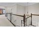 Bright hallway features a wooden banister and contemporary chandelier lighting the upstairs walkway at 11523 Warfield Ave, Huntersville, NC 28078