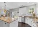 Open kitchen with granite countertops, white cabinets, stainless steel appliances, and backyard views through French doors at 11523 Warfield Ave, Huntersville, NC 28078