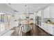A modern kitchen featuring white cabinetry, granite countertops, stainless steel appliances, and an island with bar seating at 11523 Warfield Ave, Huntersville, NC 28078