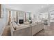 Spacious living room with a fireplace, large sectional sofa, and views into an open kitchen space at 11523 Warfield Ave, Huntersville, NC 28078