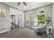 Bright living room featuring arched windows, neutral paint and carpet, and an open doorway to the foyer at 11523 Warfield Ave, Huntersville, NC 28078