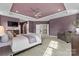 A spacious main bedroom has a sitting area, and tray ceilings with recessed lighting at 11523 Warfield Ave, Huntersville, NC 28078