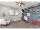 Well-lit home office featuring custom built-in shelves, modern decor, comfortable seating and a ceiling fan at 11523 Warfield Ave, Huntersville, NC 28078