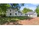 Expansive backyard with lush green grass, a detached garage, and mature trees providing ample shade at 127 Charlotte St, Mooresville, NC 28115