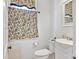 Powder room with ornate curtain and mirror, toilet and sink at 127 Charlotte St, Mooresville, NC 28115