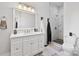 Bright bathroom features a white vanity with marble countertop and a glass enclosed shower with marble tile at 127 Charlotte St, Mooresville, NC 28115