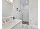 Bright bathroom with marble vanity, walk-in shower with geometric tiling, and white toilet at 127 Charlotte St, Mooresville, NC 28115