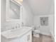 Bright bathroom with a white marble vanity and fixtures, with tile flooring and white walls at 127 Charlotte St, Mooresville, NC 28115