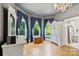 Serene bedroom is filled with natural light, complete with hardwood floors and bay windows at 127 Charlotte St, Mooresville, NC 28115