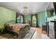 Stylish bedroom with an ornate chandelier and large windows that bring in the light at 127 Charlotte St, Mooresville, NC 28115