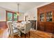 Bright dining room boasts hardwood floors, natural light, and decorative built-in cabinet at 127 Charlotte St, Mooresville, NC 28115
