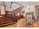 Elegant foyer showcases a detailed wood staircase and vintage fireplace, blending historical appeal at 127 Charlotte St, Mooresville, NC 28115