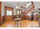 Welcoming foyer with hardwood floors, a grand staircase, and classic wood paneling at 127 Charlotte St, Mooresville, NC 28115