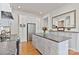 A full kitchen view with central island, stainless steel appliances and hardwood flooring at 127 Charlotte St, Mooresville, NC 28115