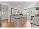 Spacious kitchen with a center island, stainless steel appliances, lots of windows and hardwood flooring at 127 Charlotte St, Mooresville, NC 28115