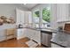 Bright and airy kitchen with stainless steel appliances, wooden floors, and granite counter tops at 127 Charlotte St, Mooresville, NC 28115