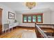 Upstairs landing featuring hardwood floors and decorative windows with a Tiffany-style light fixture at 127 Charlotte St, Mooresville, NC 28115