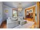 Elegant living room features hardwood floors, decorative molding, and a chandelier at 127 Charlotte St, Mooresville, NC 28115