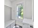 Mud room with storage, bench, window, tile flooring and white freezer at 127 Charlotte St, Mooresville, NC 28115