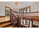 Upstairs landing featuring detailed wood trim and banister with view to the floor below at 127 Charlotte St, Mooresville, NC 28115