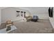 Spacious bonus room with carpet, a large window, and a comfortable seating area at 197 Tetcott St, Mooresville, NC 28115