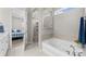 Modern bathroom featuring a soaking tub, walk-in shower, and sleek fixtures at 197 Tetcott St, Mooresville, NC 28115