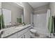 Well-lit bathroom with granite countertop, white cabinets, and shower-tub combination at 197 Tetcott St, Mooresville, NC 28115