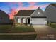 Charming home exterior featuring a two-car garage, inviting entrance, and well-manicured landscaping at 197 Tetcott St, Mooresville, NC 28115