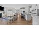 Open-concept living room showcasing hardwood floors, comfortable seating, and seamless kitchen integration at 197 Tetcott St, Mooresville, NC 28115