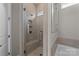 Contemporary walk-in shower features gray tiling, a built-in seat, and glass enclosure at 197 Tetcott St, Mooresville, NC 28115