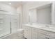 Bathroom with a double sink vanity, white cabinetry, a large mirror, and a walk-in shower with glass doors at 2039 Morning Gold Dr, Maiden, NC 28650