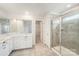 Bright bathroom with double sinks, white cabinets, white countertop, a shower, and a walk-in closet at 2039 Morning Gold Dr, Maiden, NC 28650