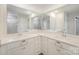 Bright bathroom with double sinks, white cabinets, white countertop, and two large mirrors reflecting the space at 2039 Morning Gold Dr, Maiden, NC 28650