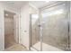 Modern bathroom featuring a glass enclosed shower with grey tile and an open door leading to another room at 2039 Morning Gold Dr, Maiden, NC 28650