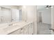 Bright bathroom with double sinks, white cabinets, white countertop, and a view of the bedroom at 2039 Morning Gold Dr, Maiden, NC 28650